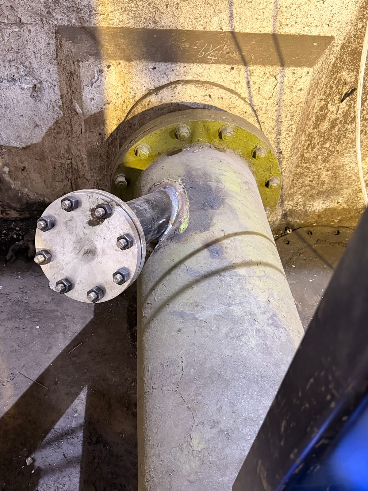Blank flange bolted onto the end of a pipe spool