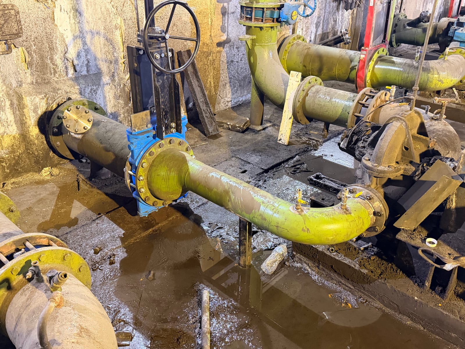 Blue knife gate valve with new prefabricated pipework running back to the existing pumps