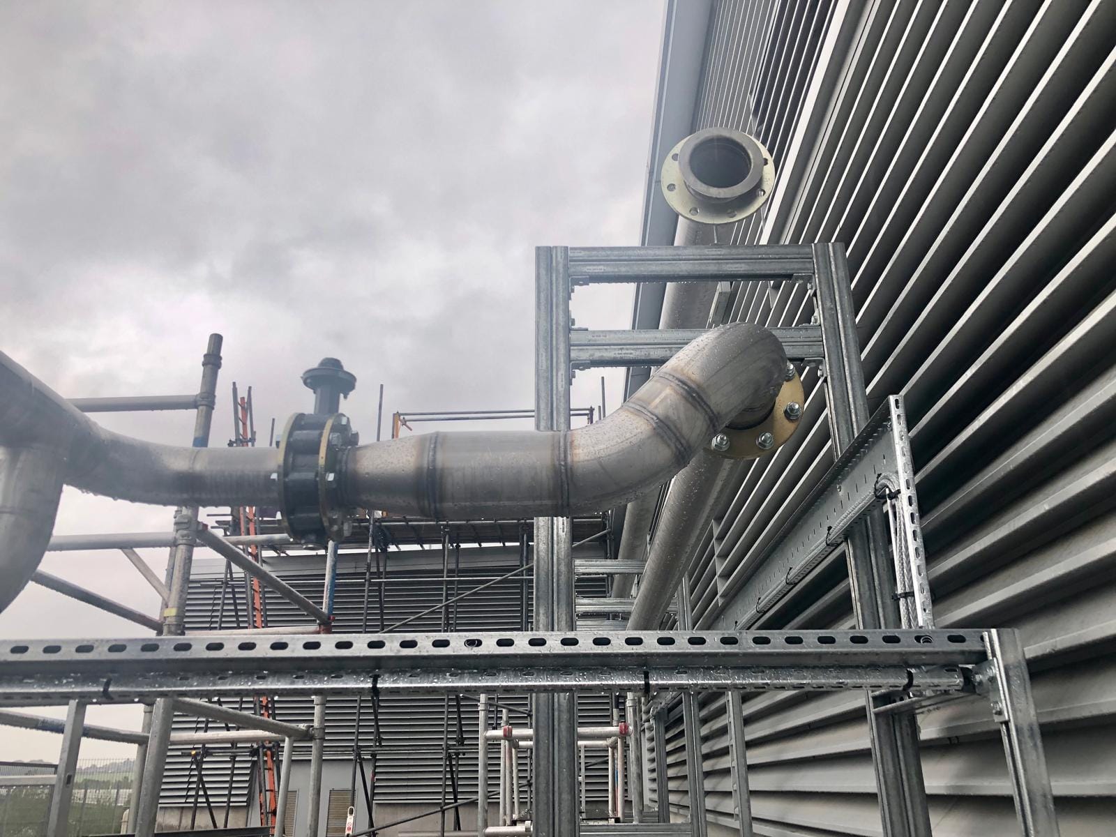Stainless steel furnace cooling pipework with flanged bends at Rolls-Royce, Sheffield