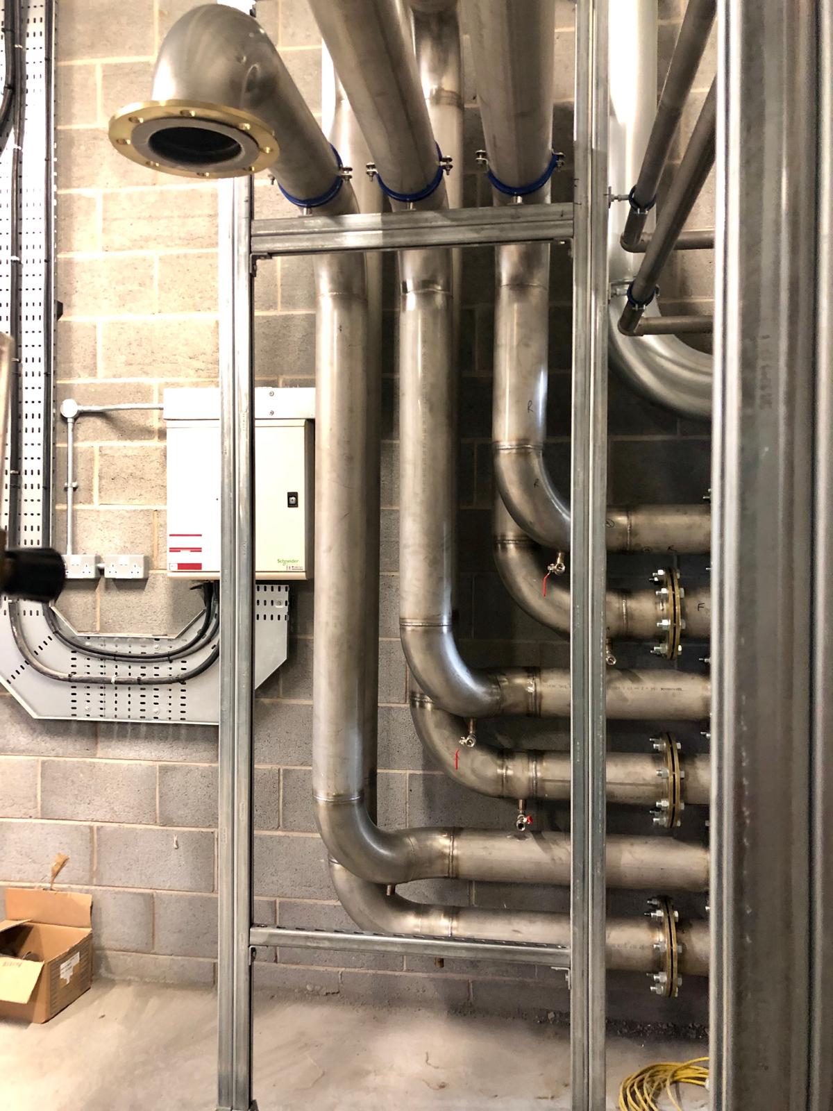 Stainless cooling lines routed around plant equipment